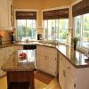 remodeling-long-white-kitchen-cabinet-in-front-of-the-windows-combined-with-used-wood-kitchen-island-on-the-cream-ceramic-floor